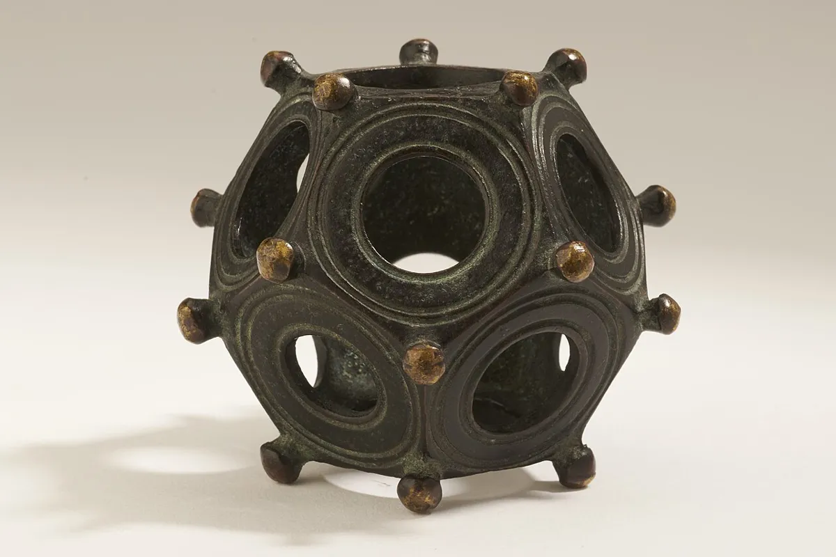 Bronze twelve-sided object with holes of different diameters